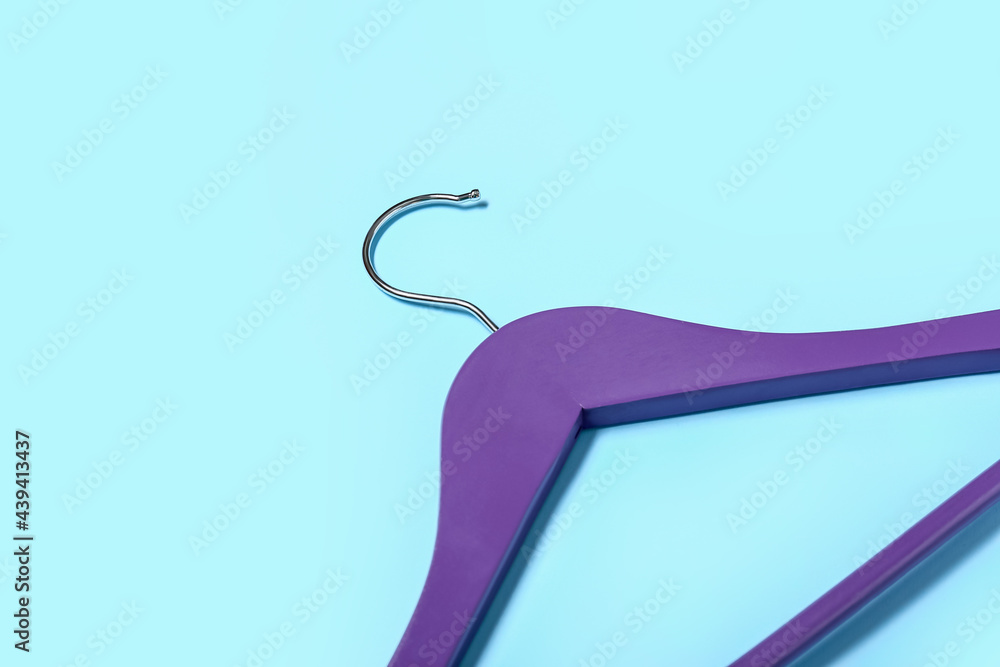 Stylish clothes hanger on color background, closeup