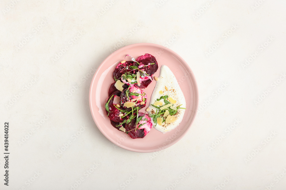 Plate with delicious beetroot carpaccio on light background