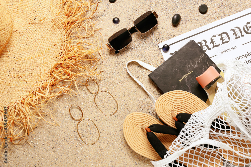 Stylish beach accessories on sand