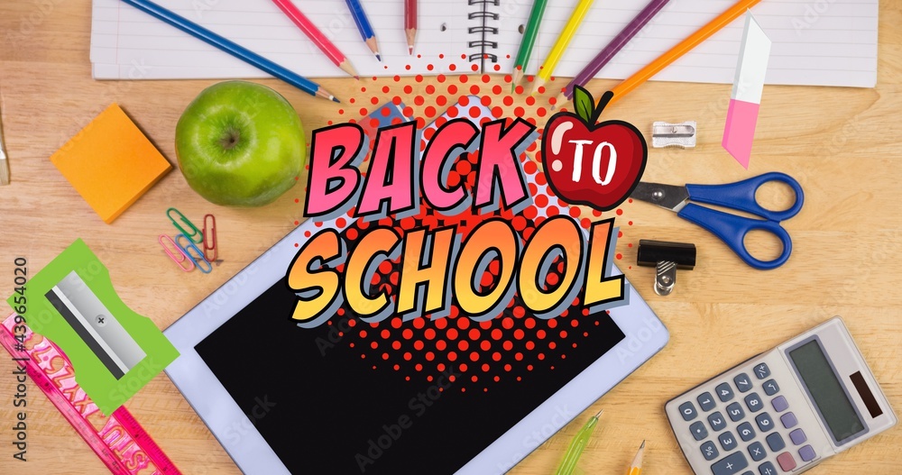 Composition of text back to school with apple, over desk with stationery, tablet and apple