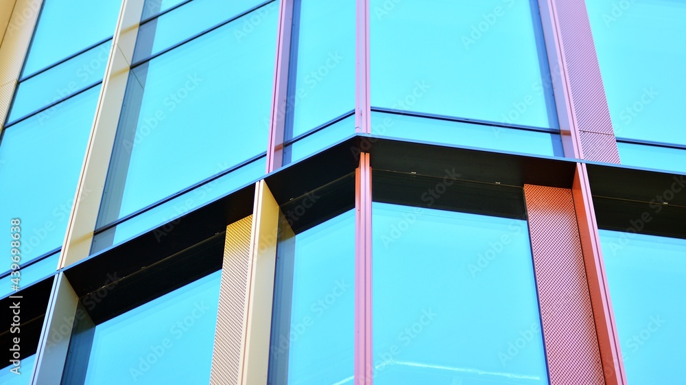 Glass facade of the buildings with a blue sky. Modern building in the business city center. Backgrou