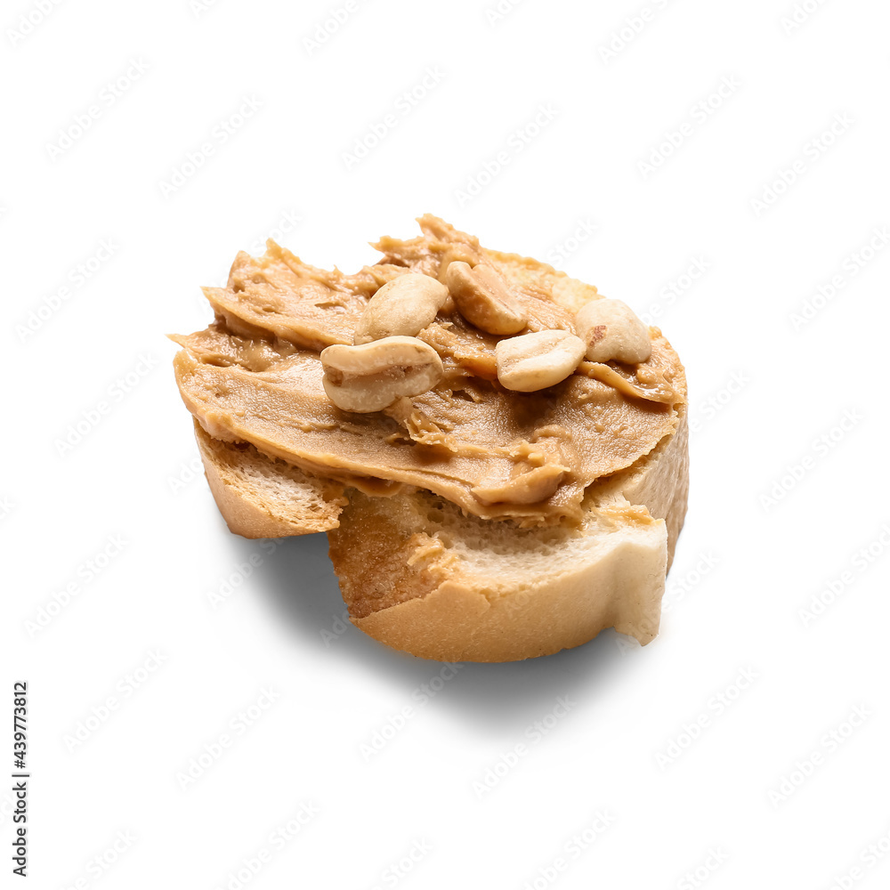 Piece of bread with tasty peanut butter on white background