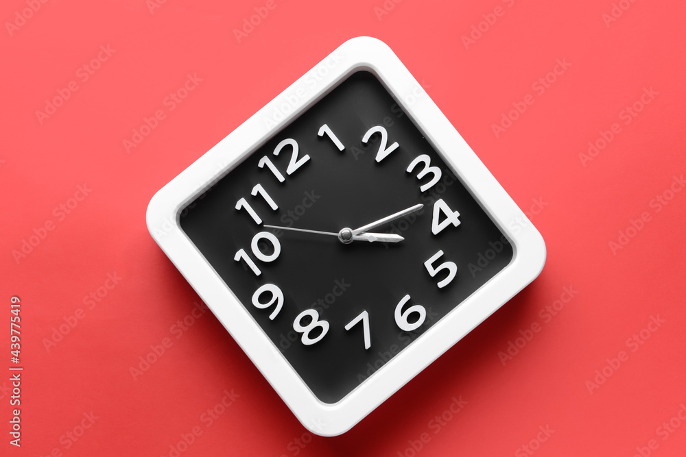 Stylish clock on color background