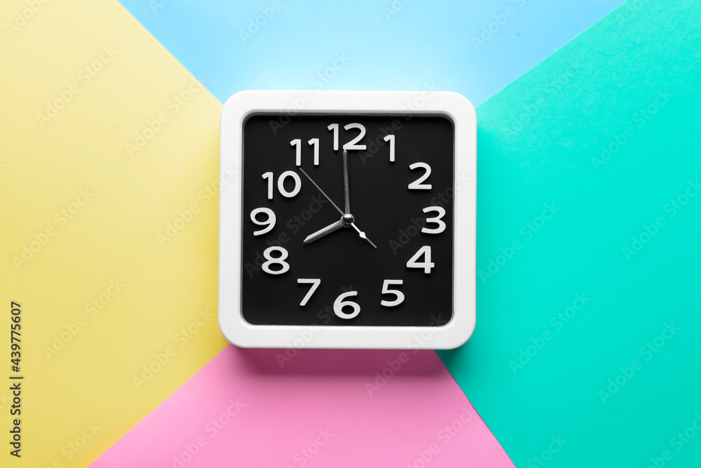 Stylish clock on color background