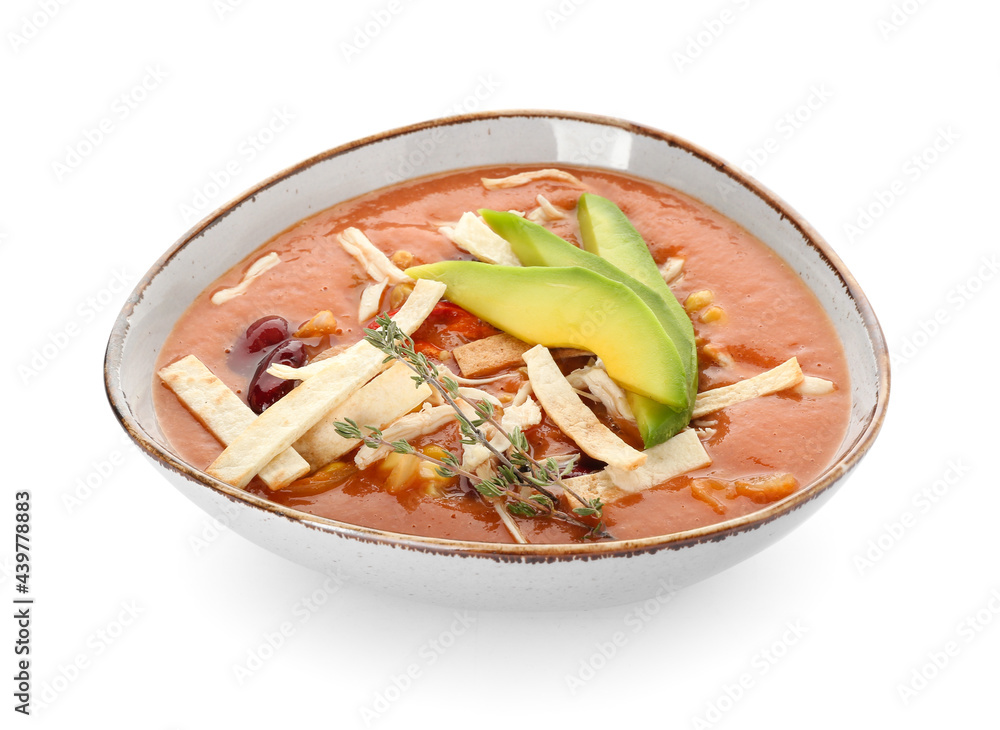 Bowl of tasty chicken enchilada soup on white background