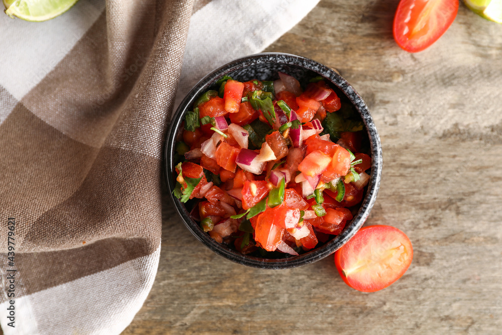 Bowl of tasty Pico de Gallo salsa on table