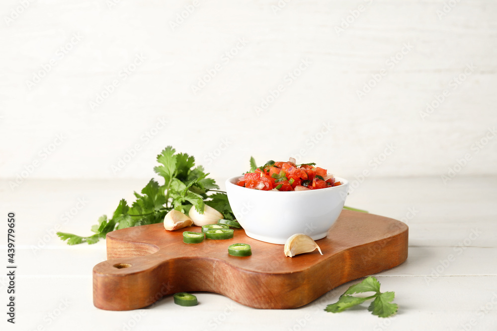 Bowl of tasty Pico de Gallo salsa on table