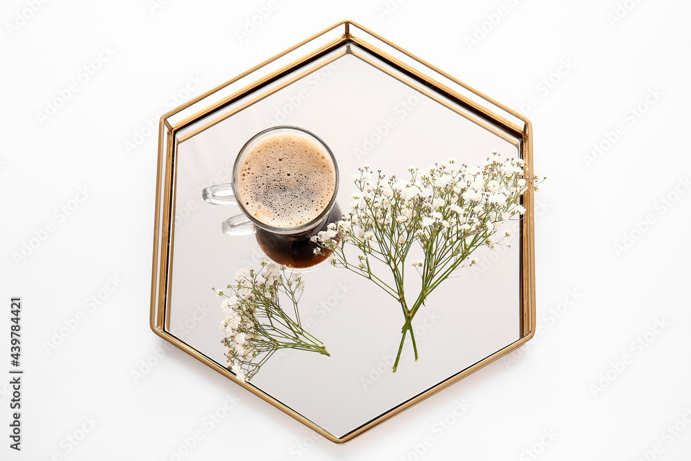 Tray with cup of coffee and beautiful gypsophila flowers on white background