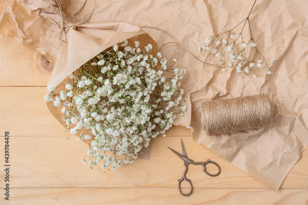 Bouquet of beautiful gypsophila flowers on wooden background