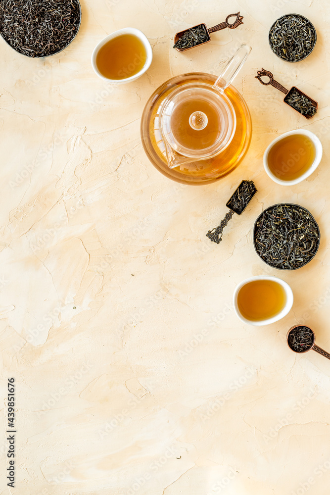 Tea ceremony concept. Hot and dry tea in teapot and cups, top view