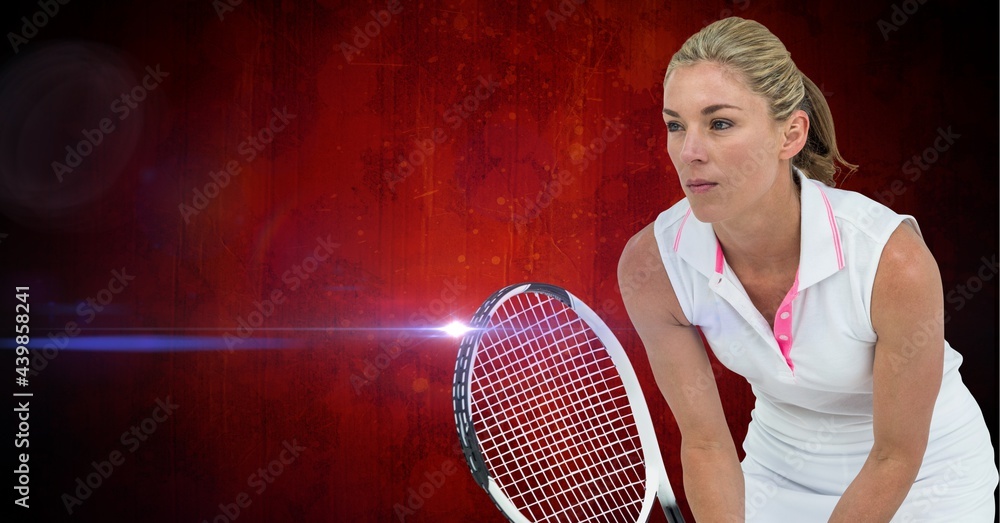 Caucasian female tennis player holding a racket against bright spot of light on red background