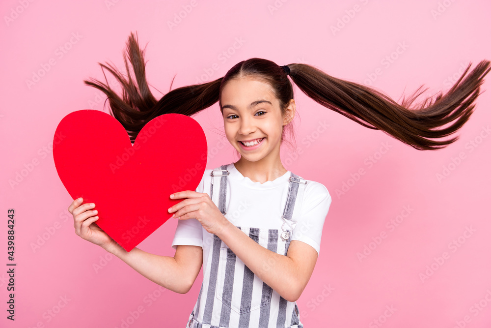 Photo of adorable happy pretty little girl good mood hold hands heart shape isolated on pink color b