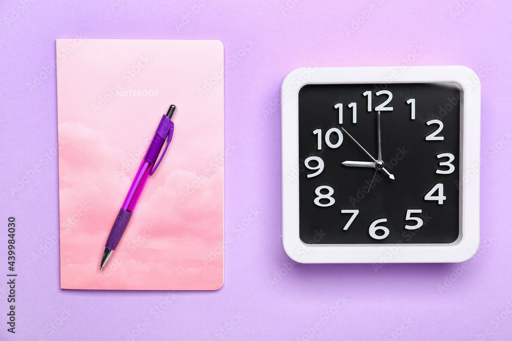 Composition with stylish clock and notebook on color background