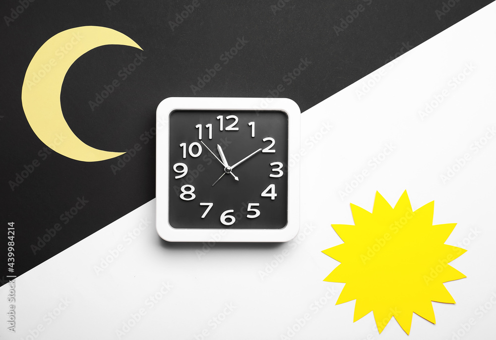 Composition with stylish clock on black and white background