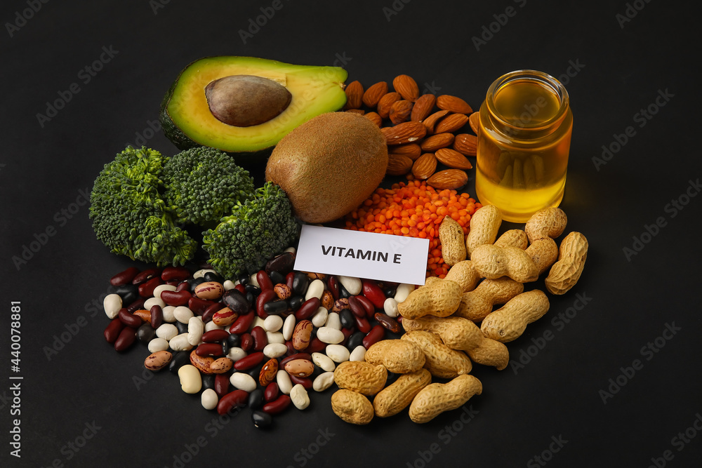 Healthy products rich in vitamin E on dark background