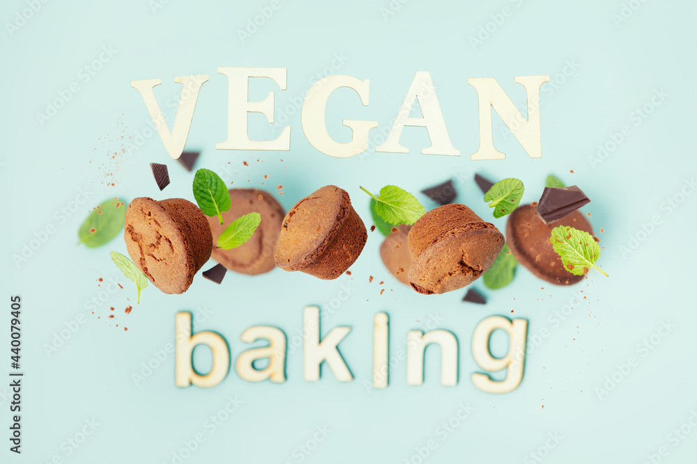 Chocolate muffins with mint leaves, vegan baking concept