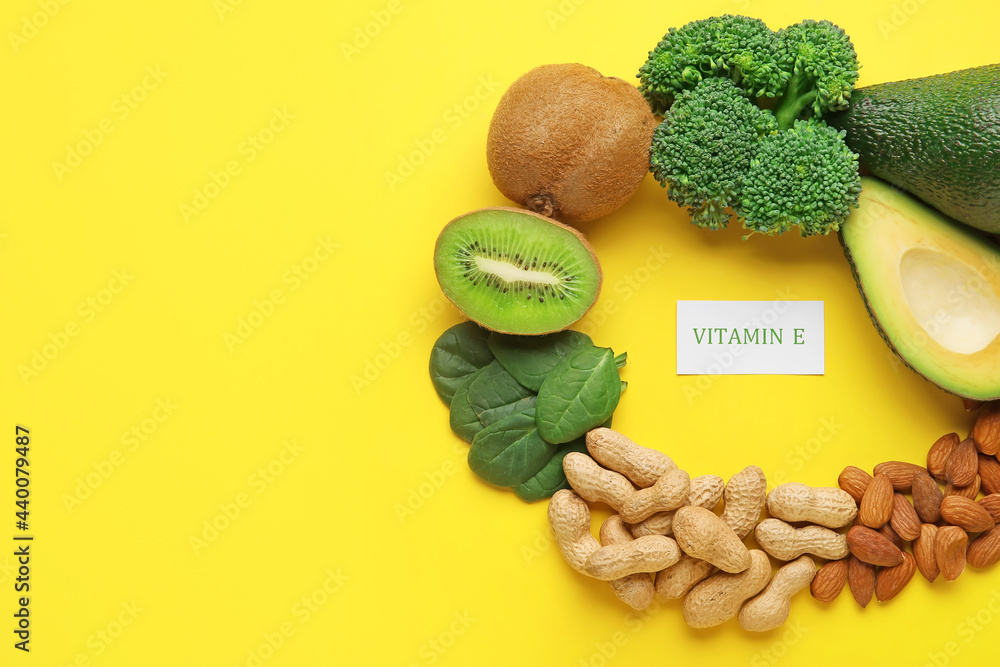 Frame made of healthy products rich in vitamin E on color background