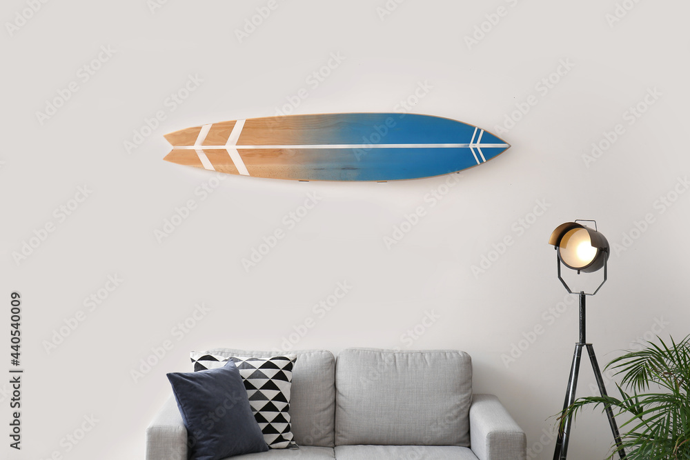 Interior of modern stylish room with surfboard and sofa