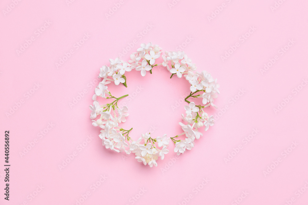 Frame made of beautiful lilac flowers on color background