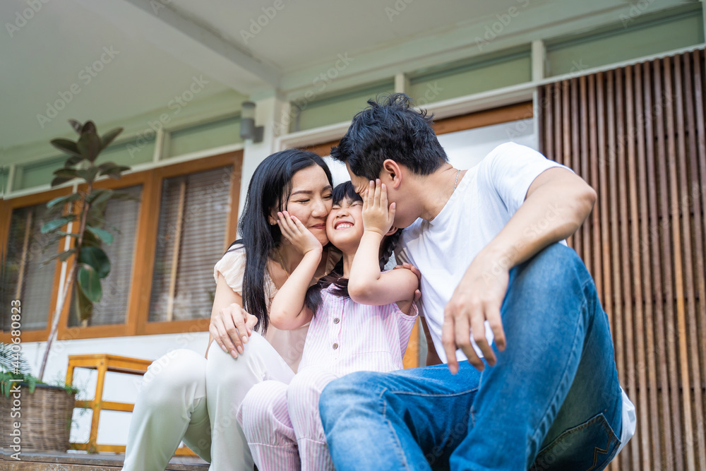 Asain happy family spend time together in garden in front of house.