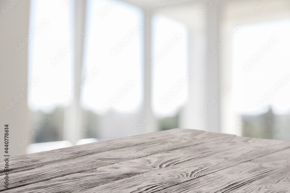 Blank wooden table top on blur room background