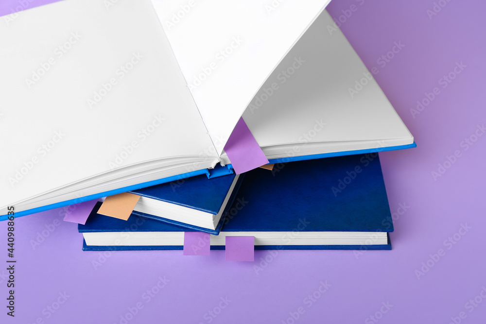 Books with bookmarks on color background