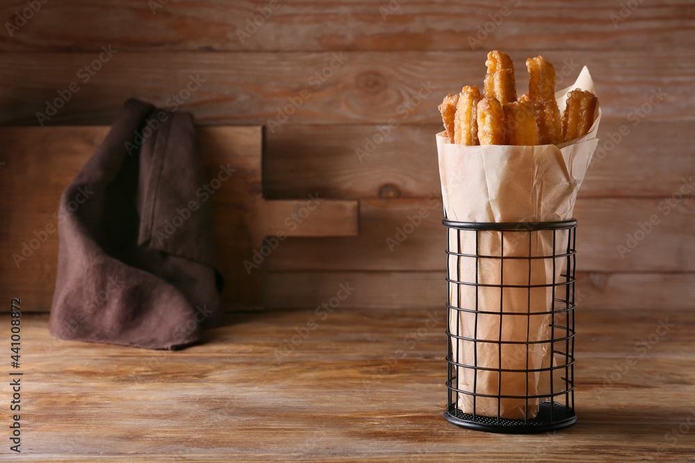 Tasty churros on wooden background