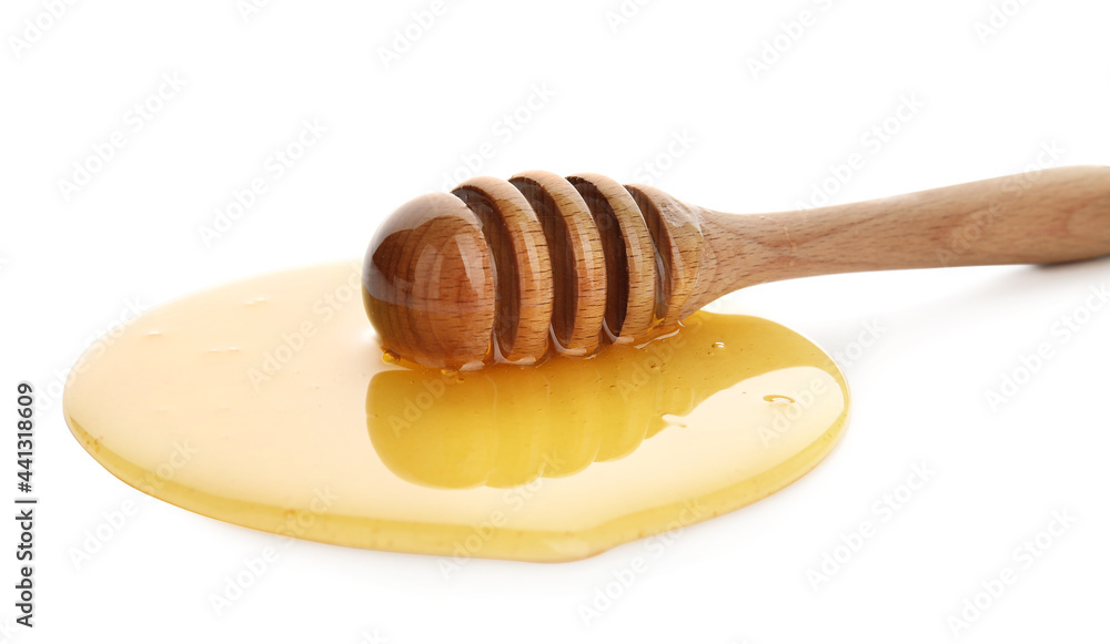 Wooden dipper and spilled honey on white background