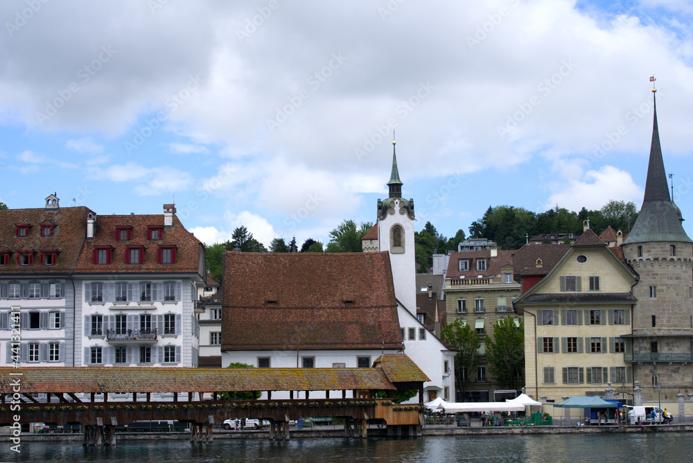 Medieval old town of Lucerne with famous Kappelbrücke (Chapel Bridge) on a cloudy summer day with ri