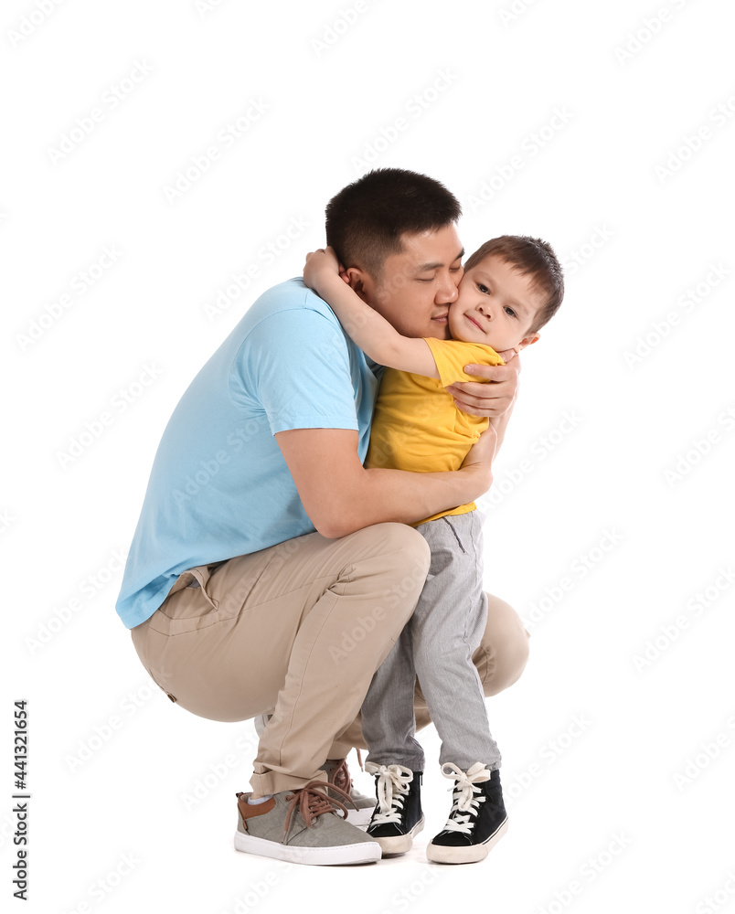 Happy father and his little son hugging on white background