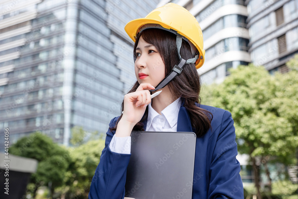 Beautiful Asian woman outdoors, wearing a suit