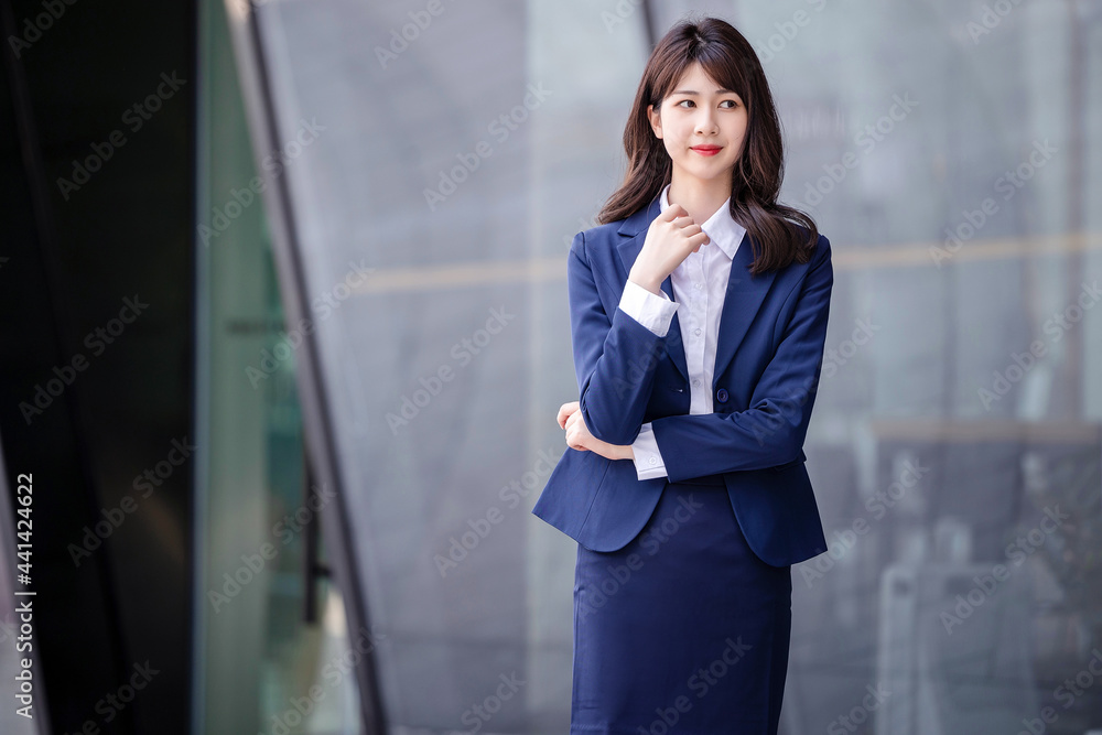 Beautiful Asian woman outdoors, wearing a suit