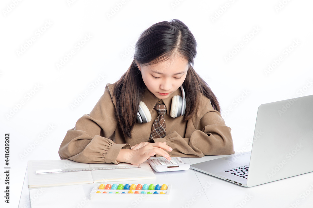 Little Asian girl receiving online education on white background