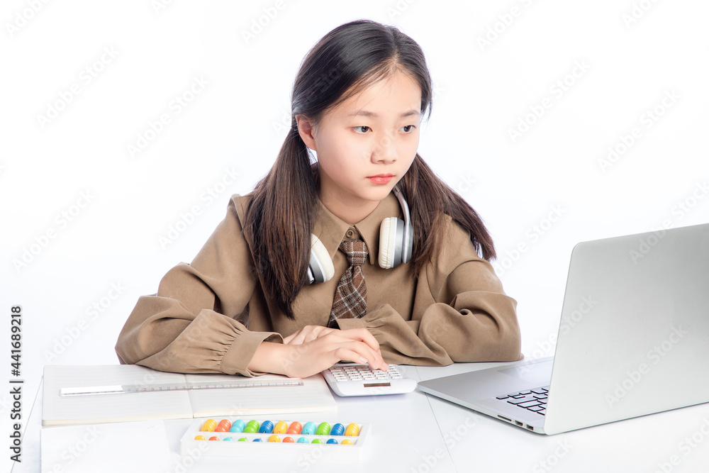 Little Asian girl receiving online education on white background