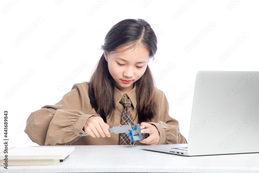 Little Asian girl receiving online education on white background