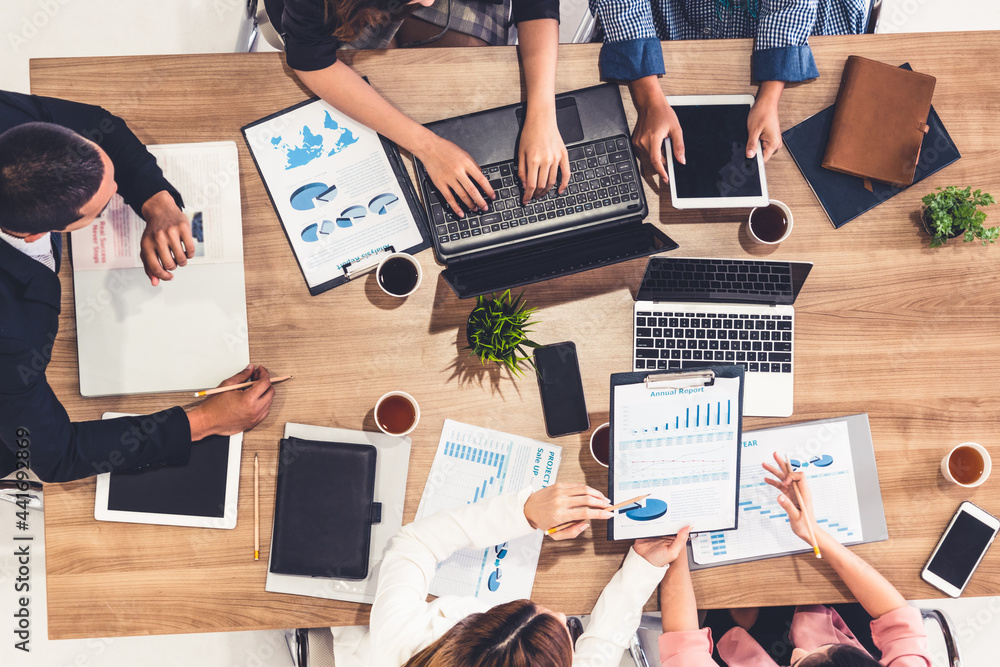 Top view of businessman executive in group meeting with other businessmen and businesswomen in moder