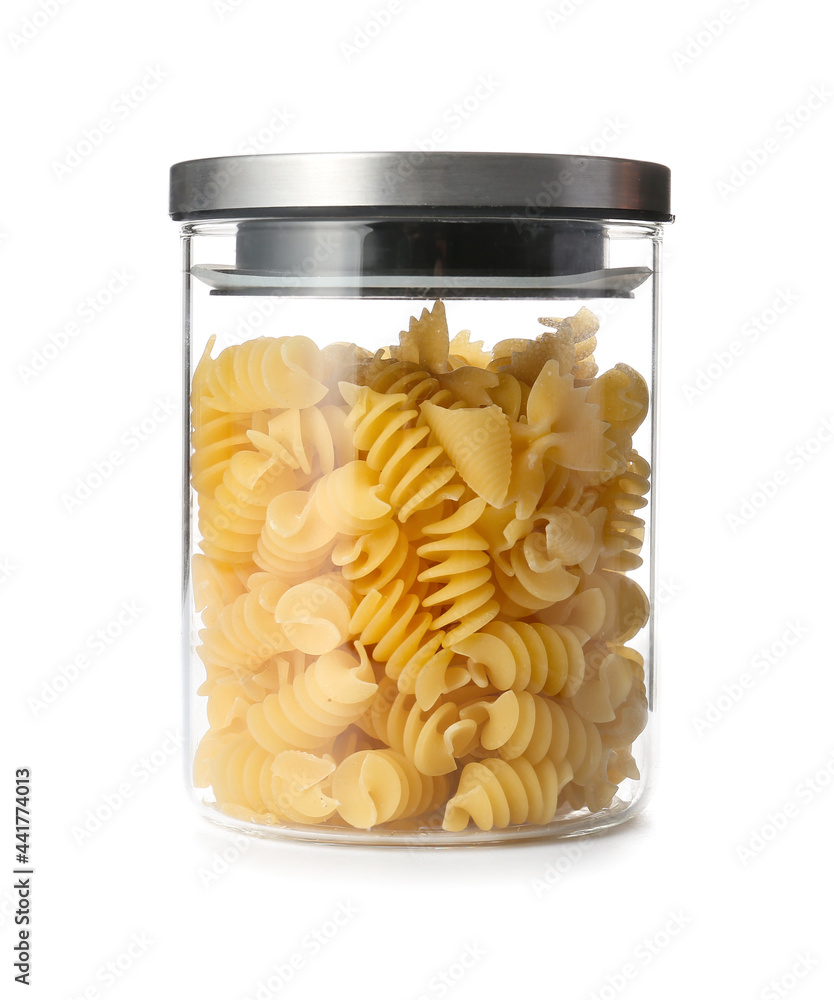 Glass jar with raw pasta on white background