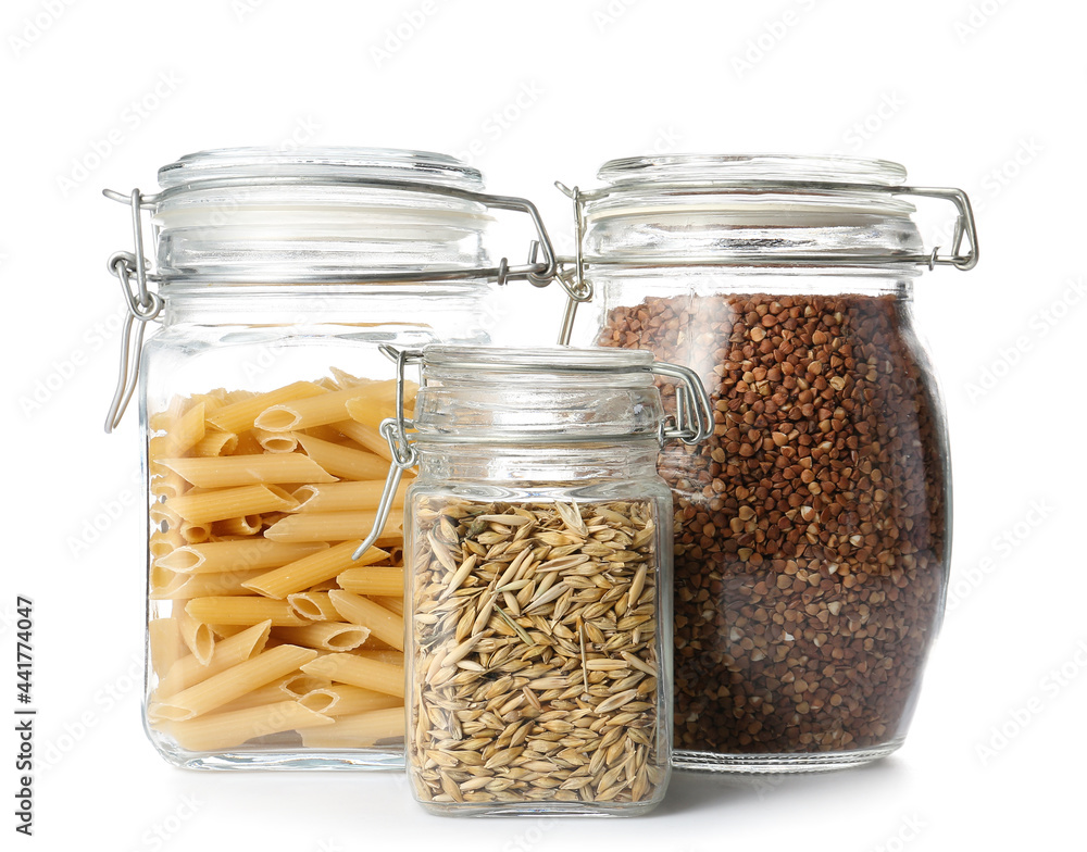 Glass jars with different products on white background