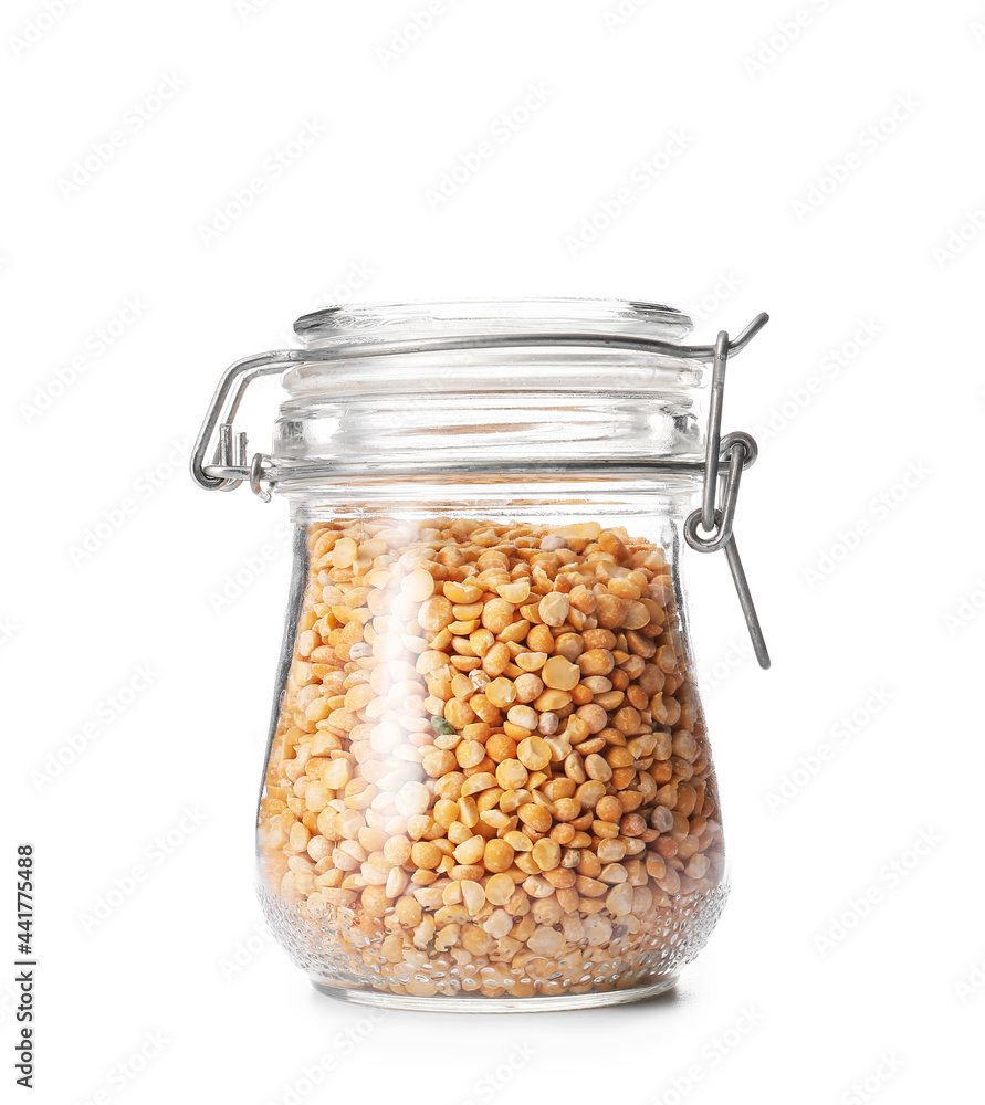 Glass jar with dry split peas on white background