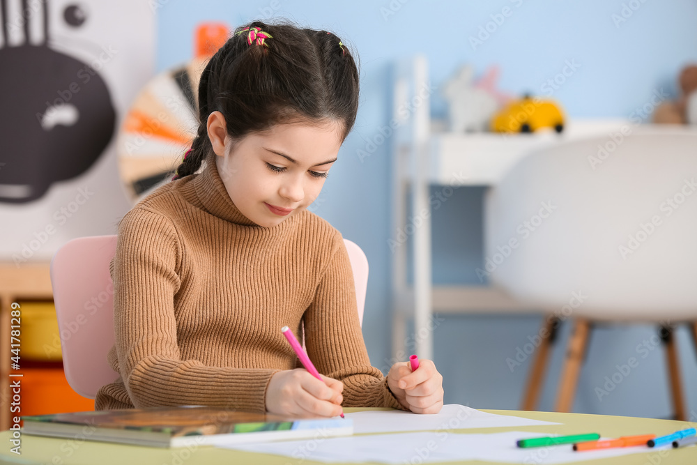 Little girl drawing at home