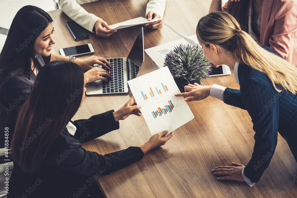 Businesswoman in group meeting discussion with other businesswomen colleagues in modern workplace of