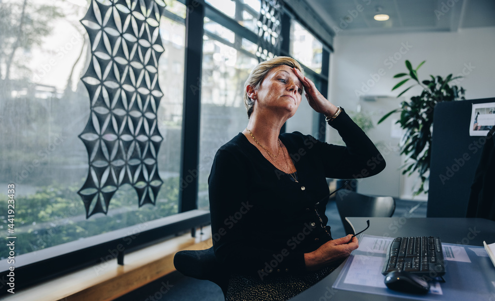 Stressed out businesswoman at her office desk