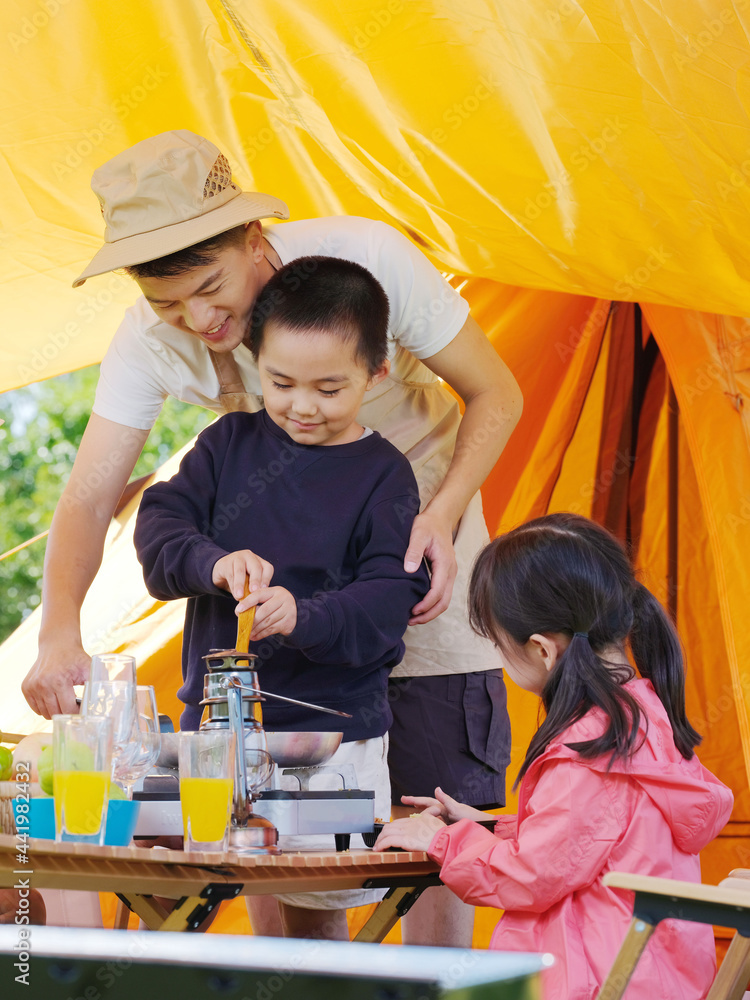 A happy family of three having a picnic outdoors