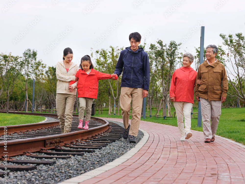 A happy family of five walking outdoors