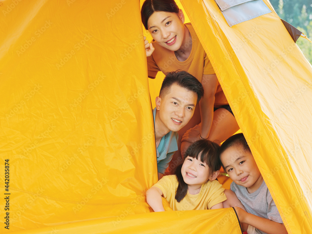 A Happy family of four in tent