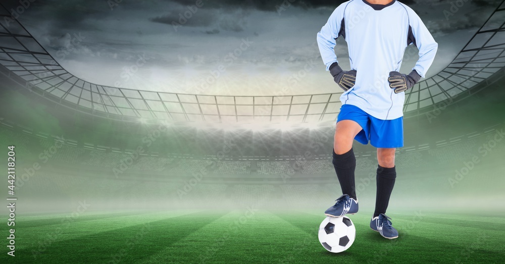 Composition of male football player with ball at stadium