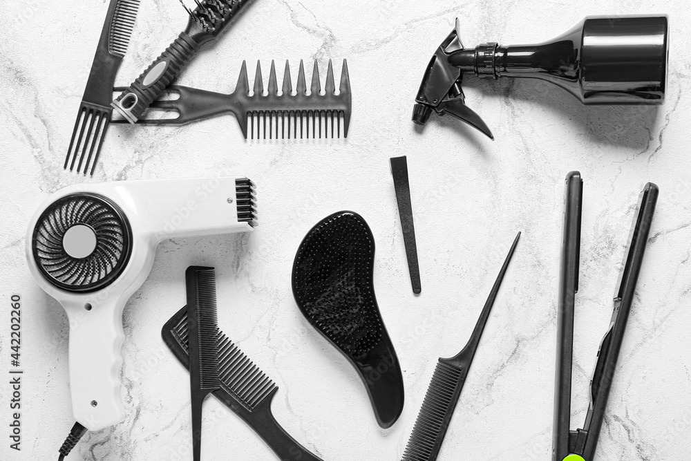 Set of hairdressers tools on light background