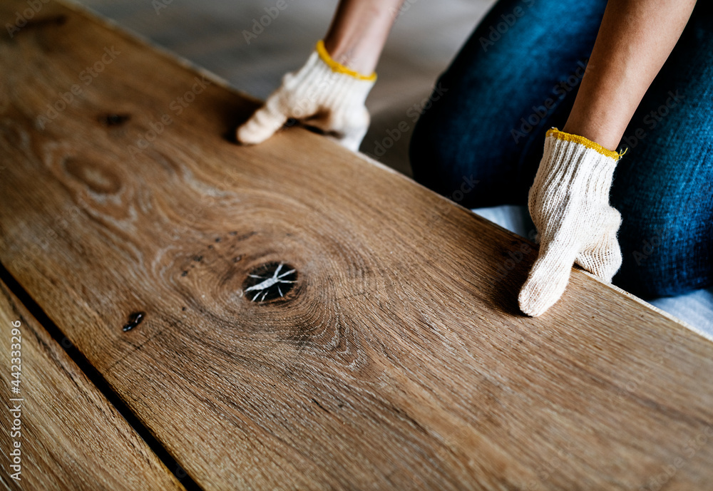 Carpenter man installing wooden floor