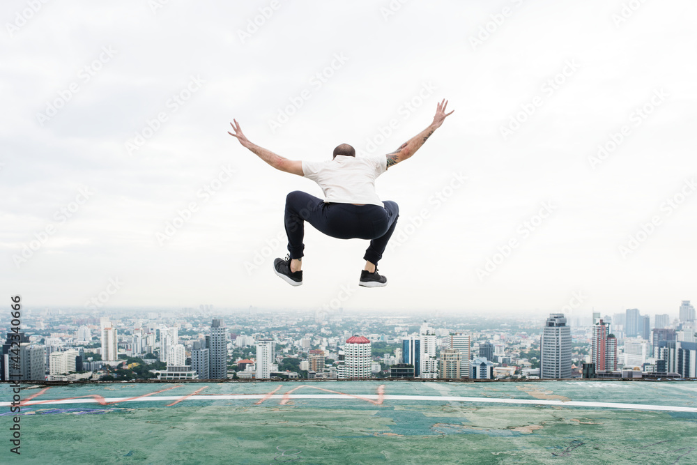 Man jumping on the rooftop