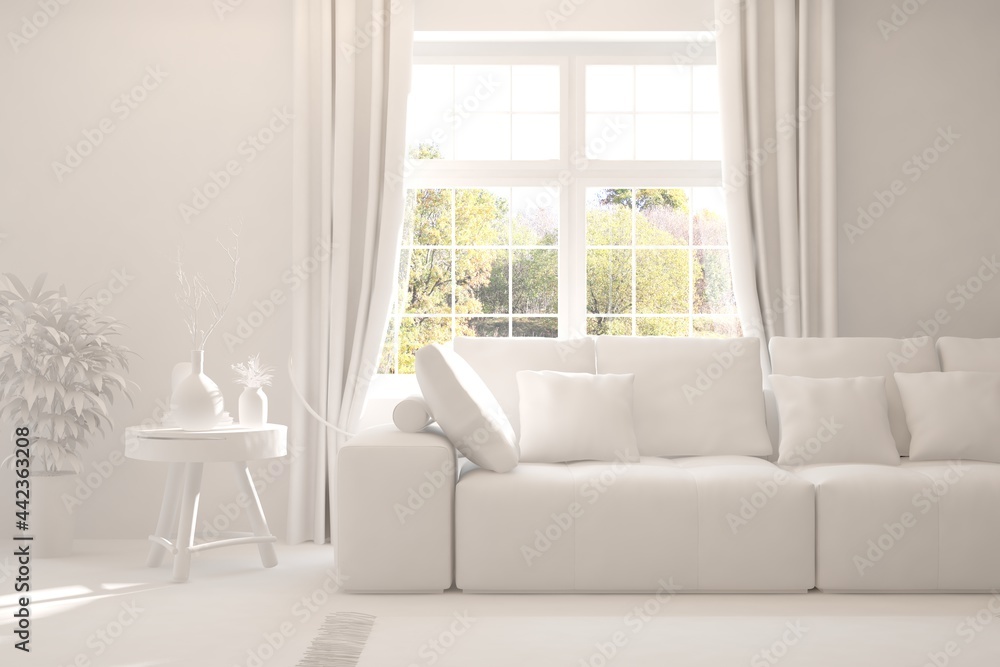 Stylish room in white color with sofa and autumn landscape in window. Scandinavian interior design. 